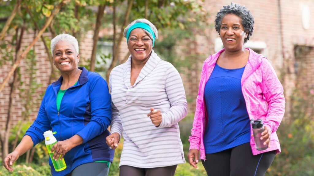 senior citizens exercising by walking increasing their fitness